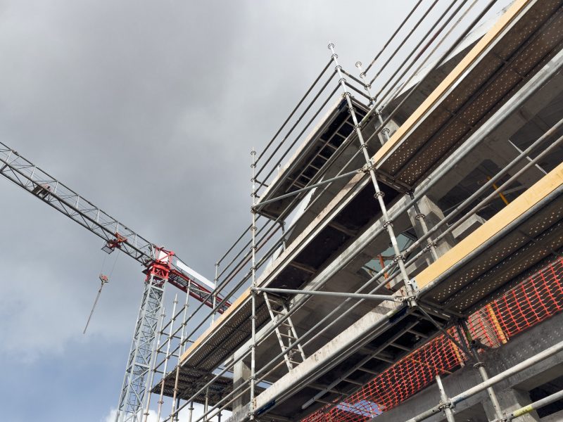 Building construction site with crane and scaffolds